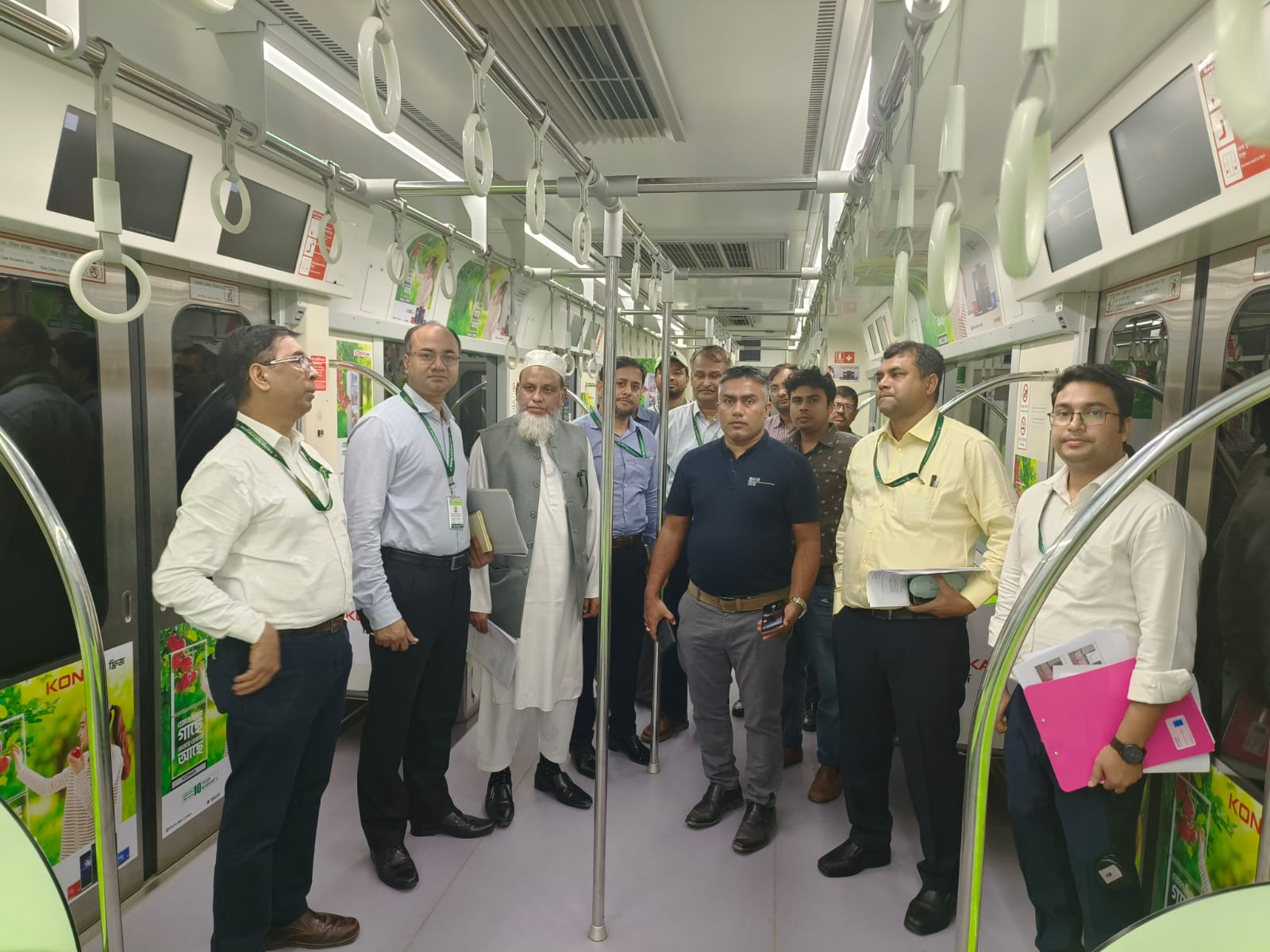 Gazzali team reviewing Konka panels inside an MRT coach